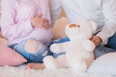 Pregnant surrogate with supportive partner representing surrogate compensation and financial support